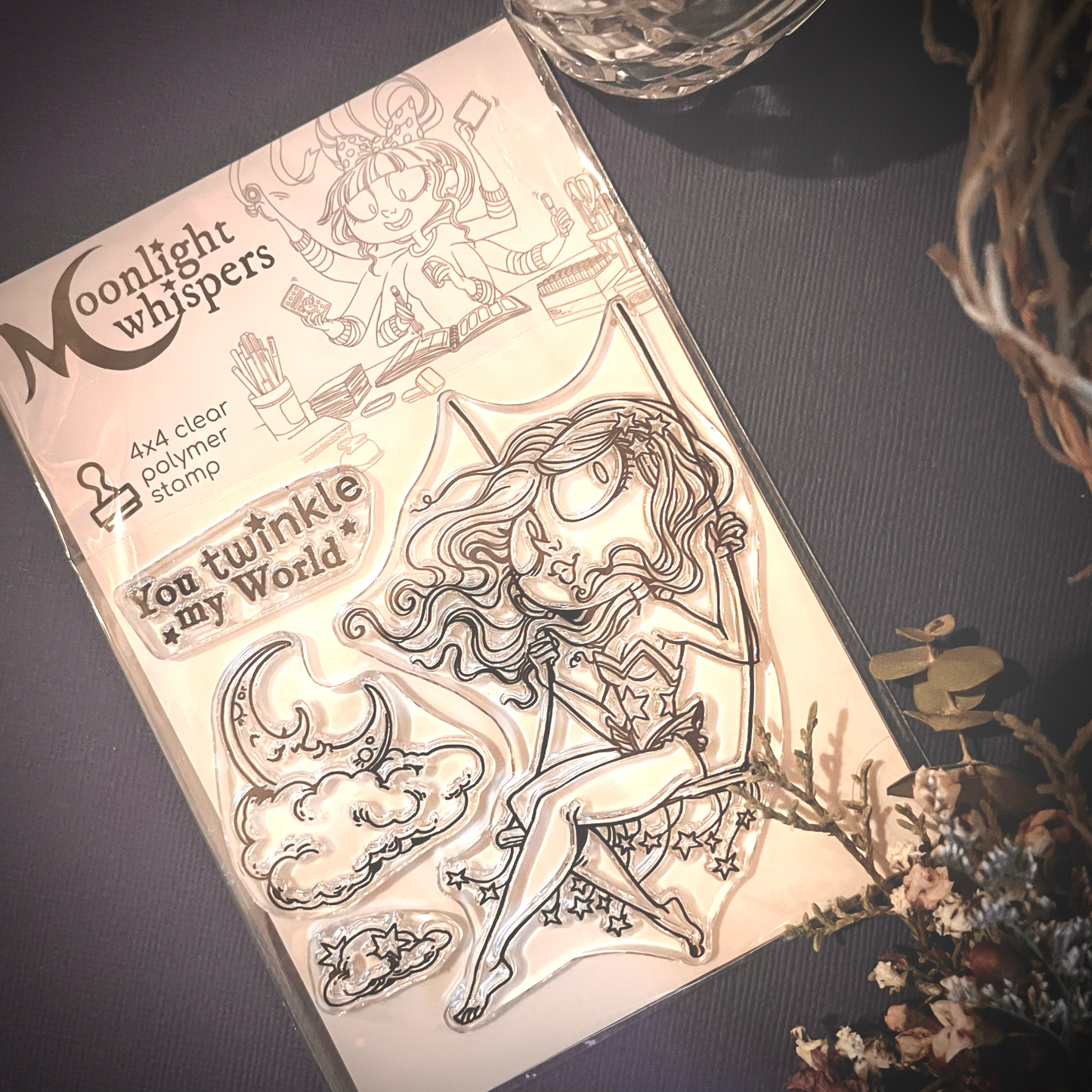 The Glittering Trapezist is a clear polymer stamp of a lovely circus lady swaying on a starry trapeze. She also comes with a sentiment and cloud and moon accessories.